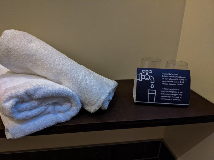 Towels and drinking glasses at a private hot pool at Franz Josef Glacier Hot Pools