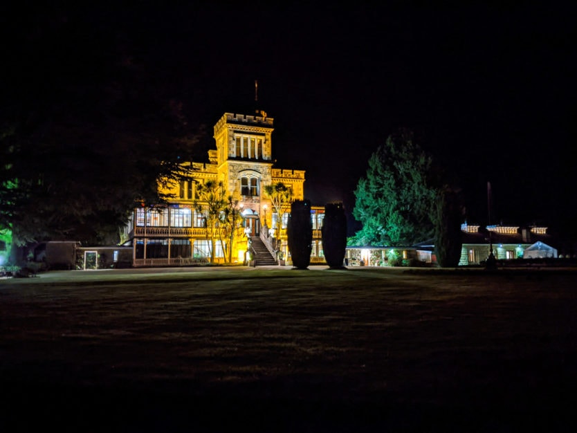 larnach castle in dunedin at night with gardens