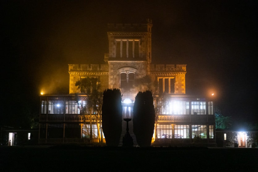 larnach castle in dunedin at night with gardens