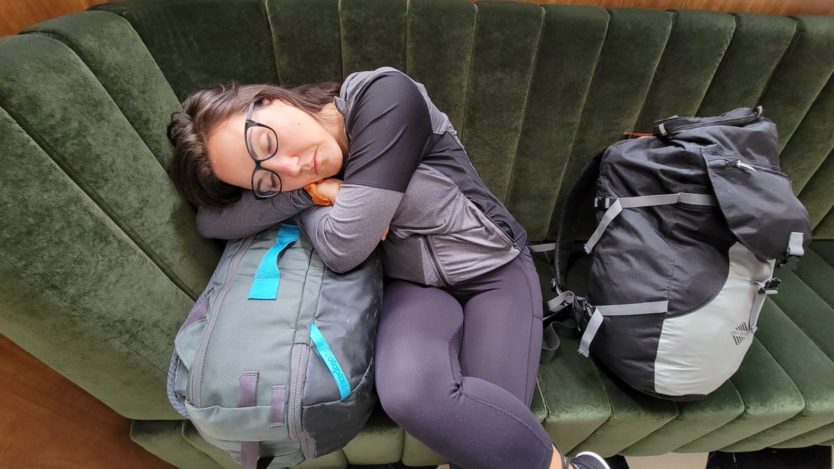 tired traveler napping on bags